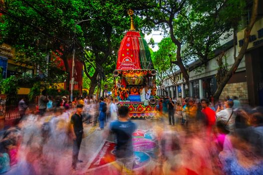 Colorful Rath Yatra procession in Kolkata, India, capturing lively street celebration.