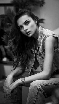 Elegant black and white portrait of a woman in denim fashion.