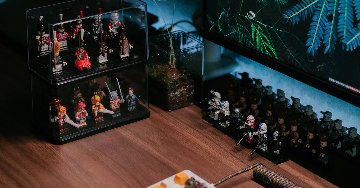 Collection of Action Figures Displayed on a Desk with a Computer ...
