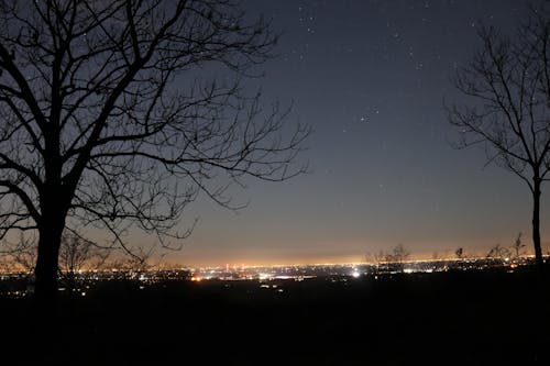 Foto profissional grátis de céu noturno, cidade da noite, estrelas