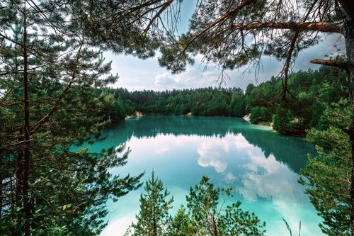 Free Scenic view of a tranquil forest lake reflecting the sky in Minsk Region, Belarus. Stock Photo