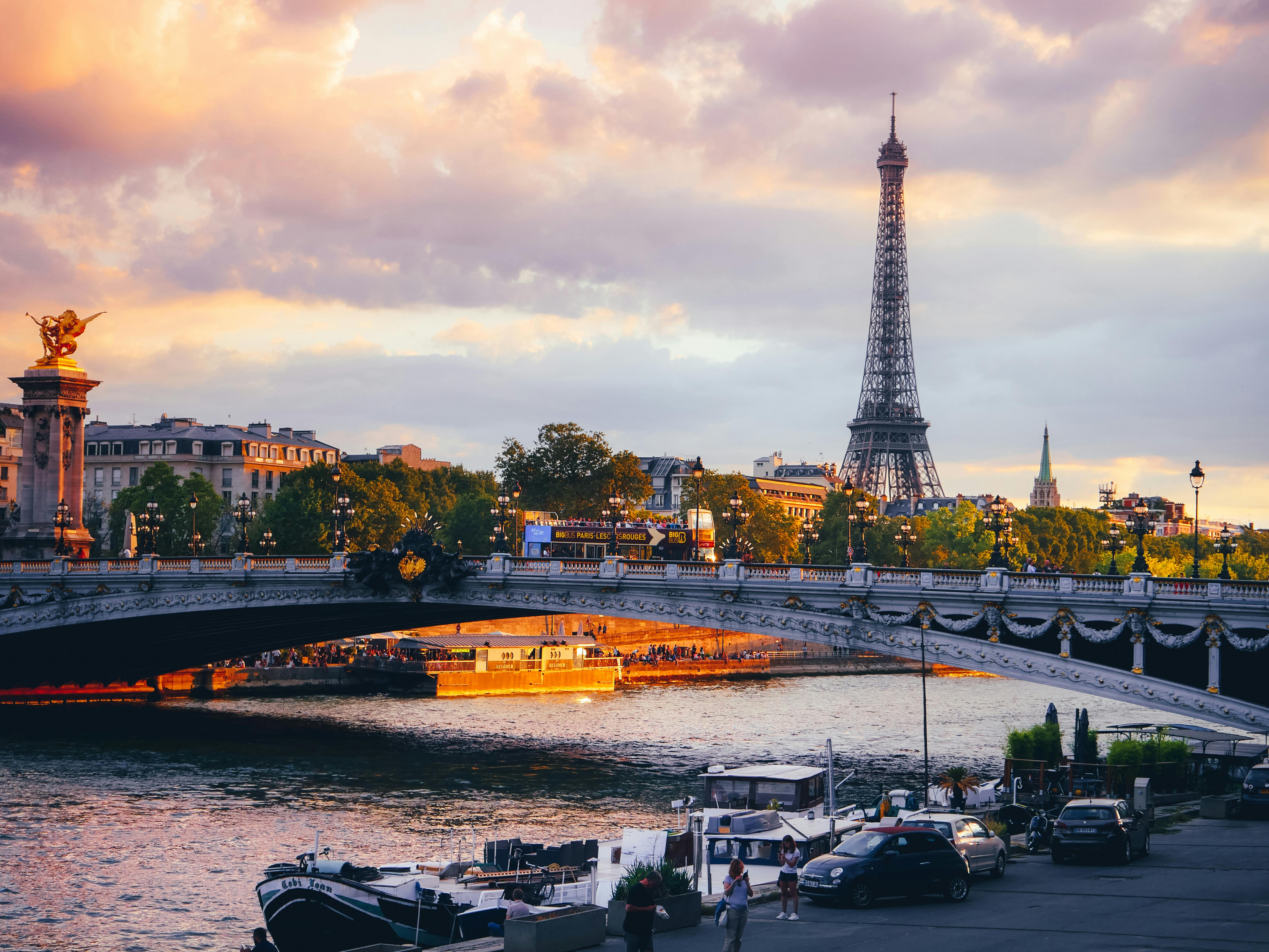 view of a bridge in paris at sunset