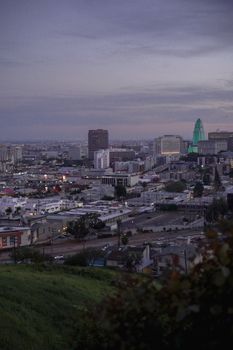 Stunning twilight view of downtown Los Angeles skyline with city lights and vibrant sky.