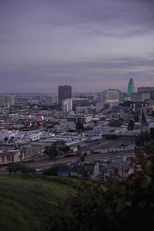 Free Stunning twilight view of downtown Los Angeles skyline with city lights and vibrant sky. Stock Photo