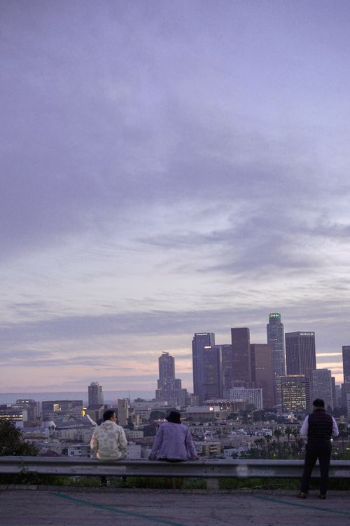 Free Skyline view of Los Angeles at sunset with people observing from a distance. Stock Photo