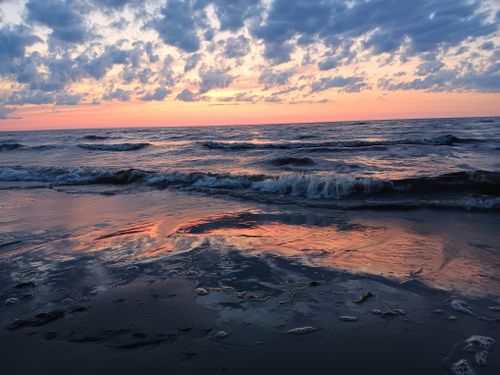 Free Serene sunset view over the Baltic Sea, reflecting vibrant colors on the water in Jurmala, Latvia. Stock Photo