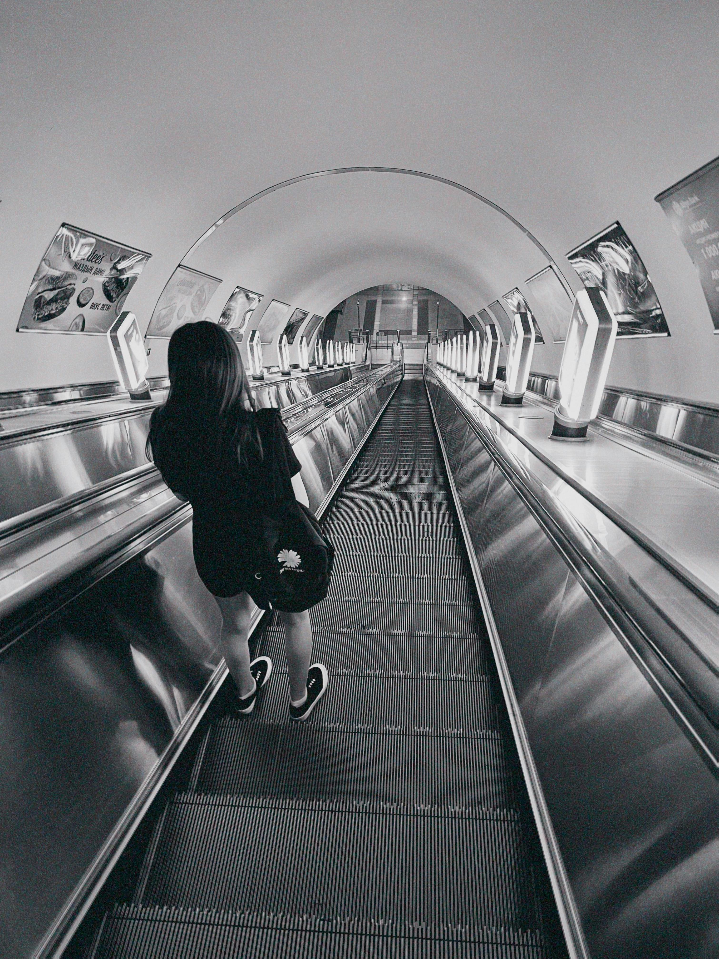 young woman on escalator