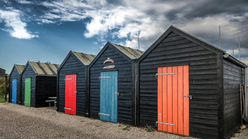 Black Beach Huts with Colorful Doors