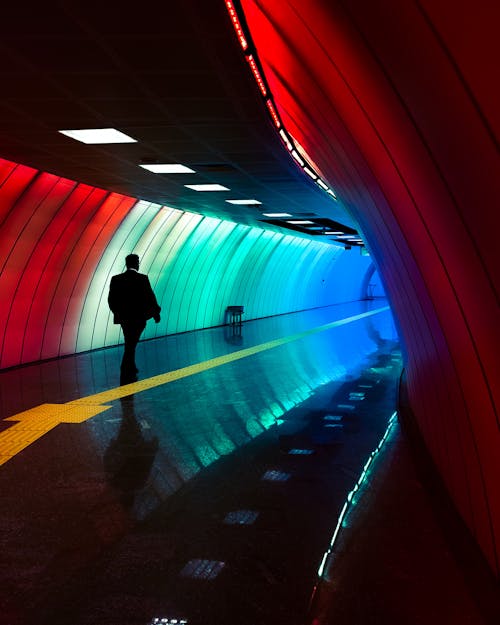 Man in Suit Walking on Modern Subway Station