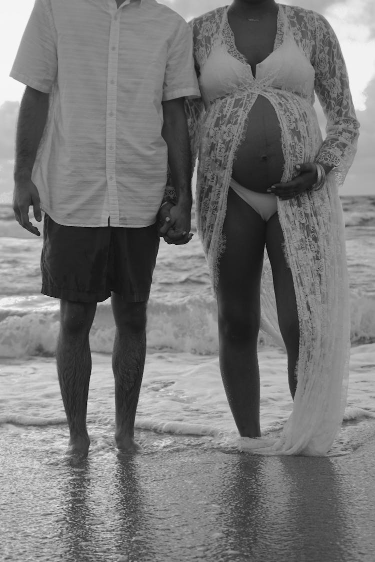 A Pregnant Couple On The Beach