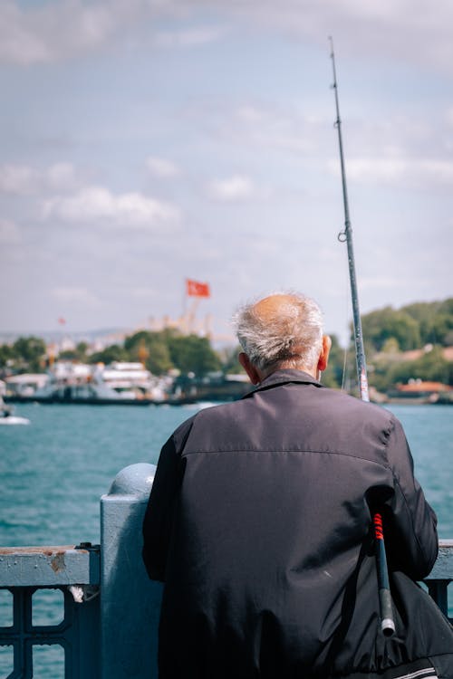 Back View of an Elderly Man with a Fishing Rod