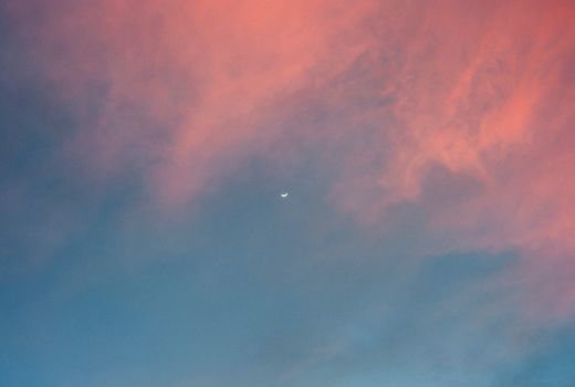 A serene pastel sky featuring a crescent moon at twilight, perfect for peaceful aesthetics.