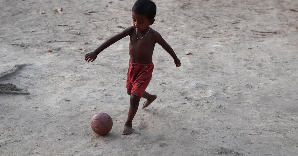Little boy in a motion to kick the ball