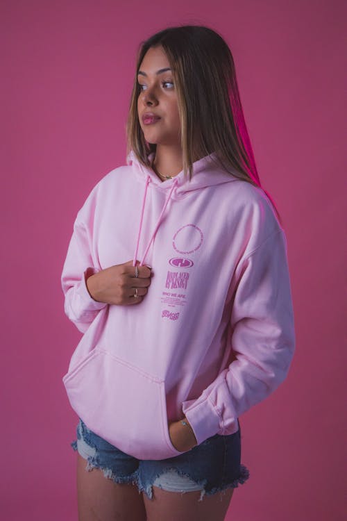 Woman in Pink Hoodie and Denim Shorts