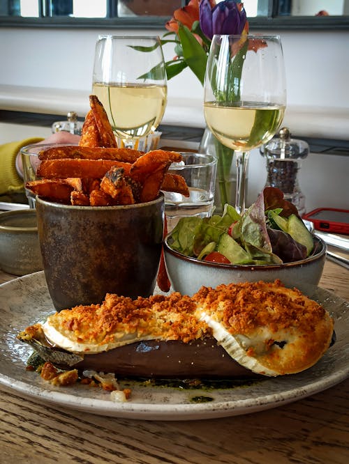 Plate with Roasted Eggplant, and White Wine Glasses