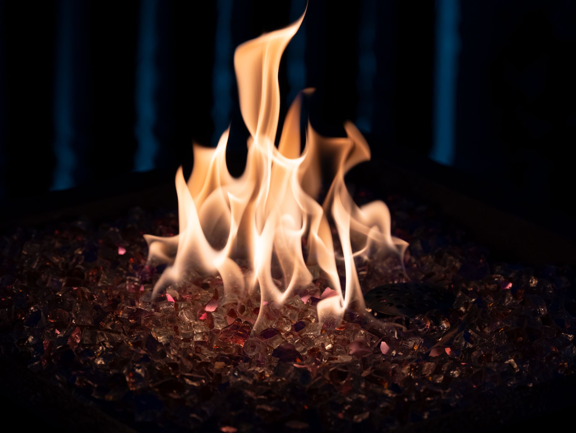 Captivating image of flames dancing over crystals against a dark background.
