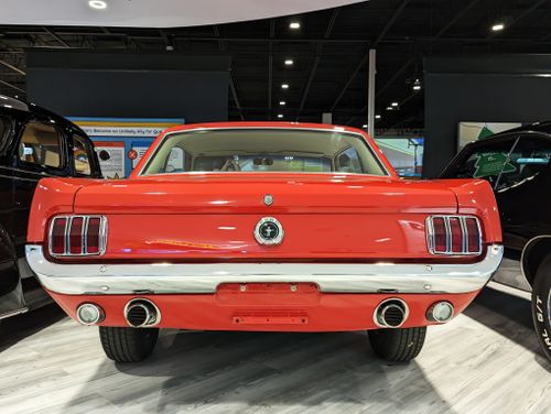 Free Rear view of a classic red Ford Mustang indoors, showcasing vintage car design. Stock Photo