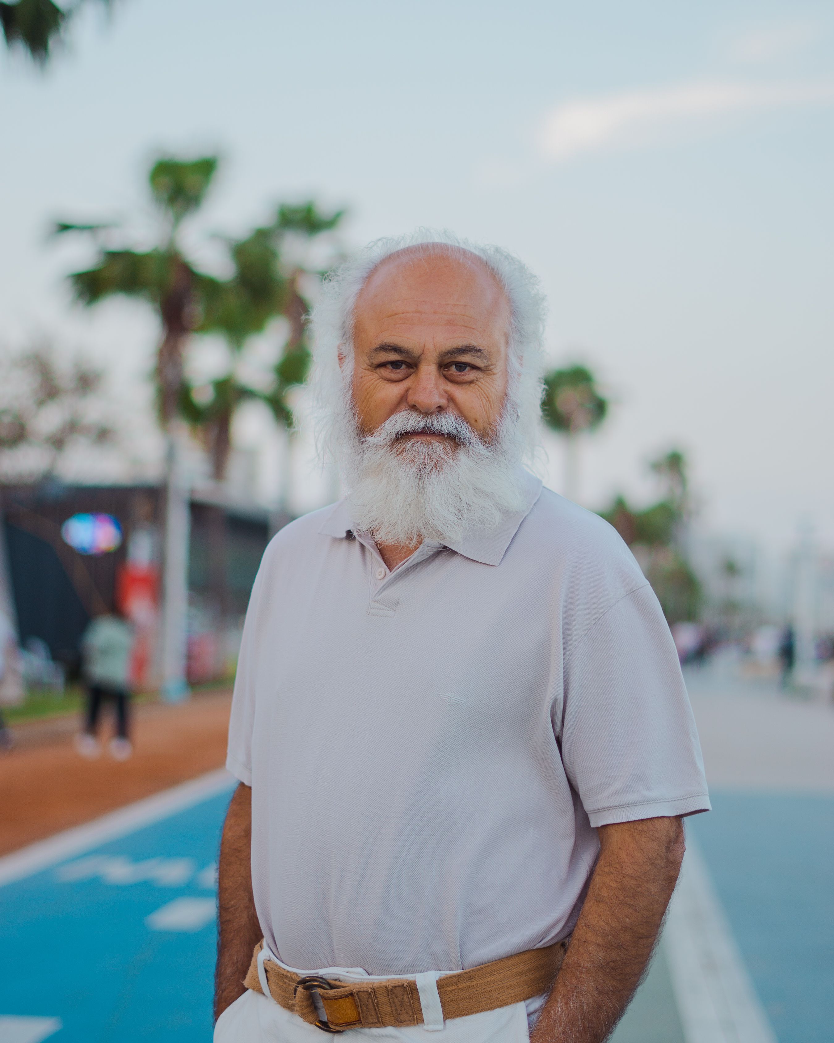 Elderly man with gray beard and mustache standing outside in Mersin, Türkiye.