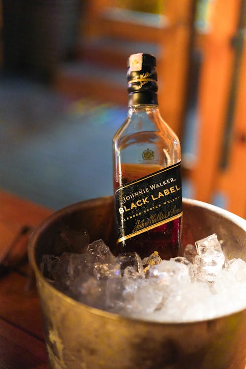 A Bottle of Whisky in a Bucket with Ice