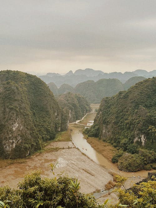 Aerial View of a River between Rocky Mountains in Ninh Binh, Vietnam 