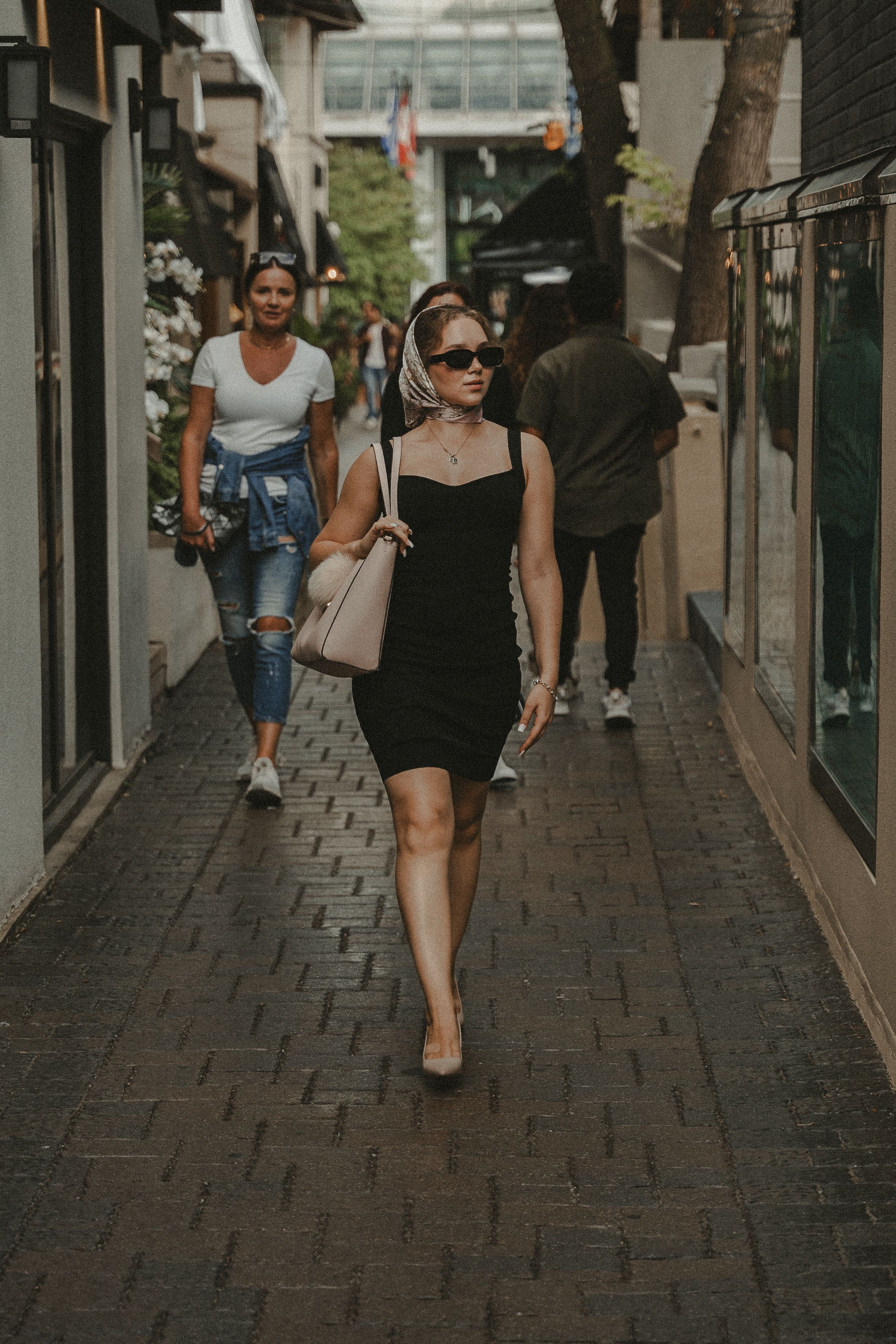 Beautiful Woman in Black Dress Walking in the Street  Free Stock Photo