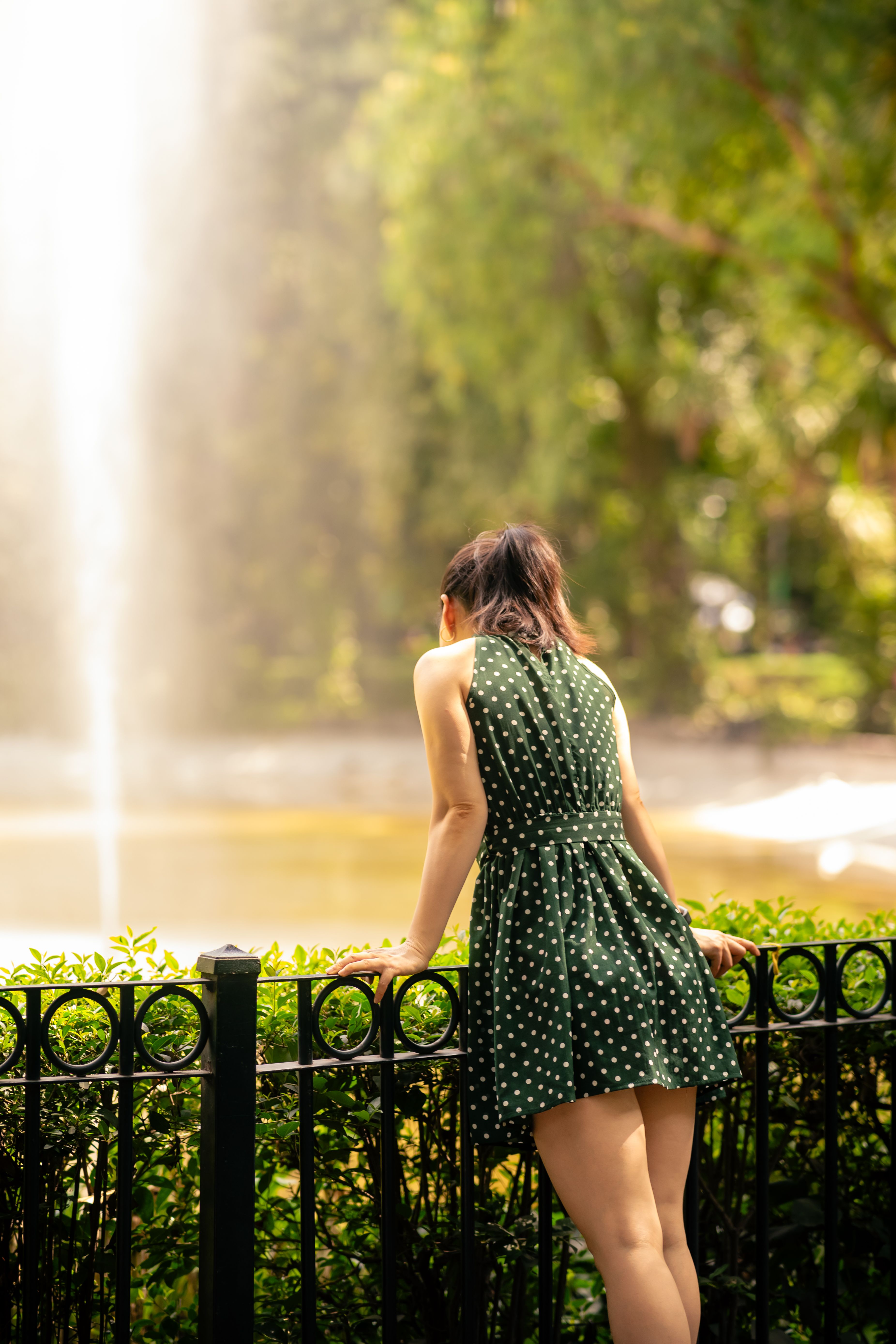 Woman in Green Dress Standing near Fountain · Free Stock Photo