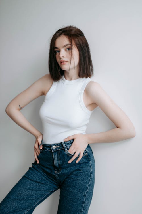 Portrait of a Female Model Wearing a White Halterneck and Jeans