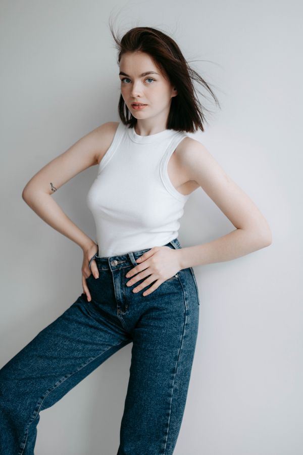 Woman in baggy jeans and fitted tank top