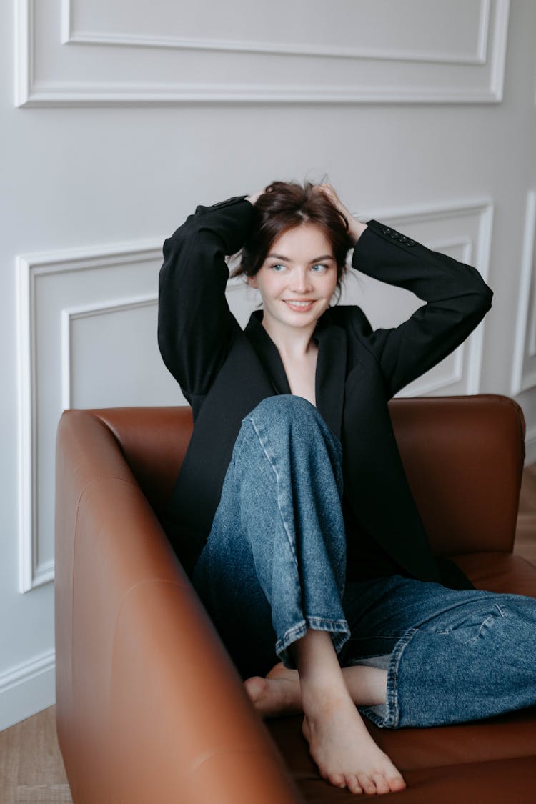 Smiling Woman Sitting On Couch