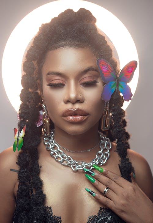 Portrait of a Young Woman Wearing Makeup and Having Butterfly Decorations Pinned to Her Hair 