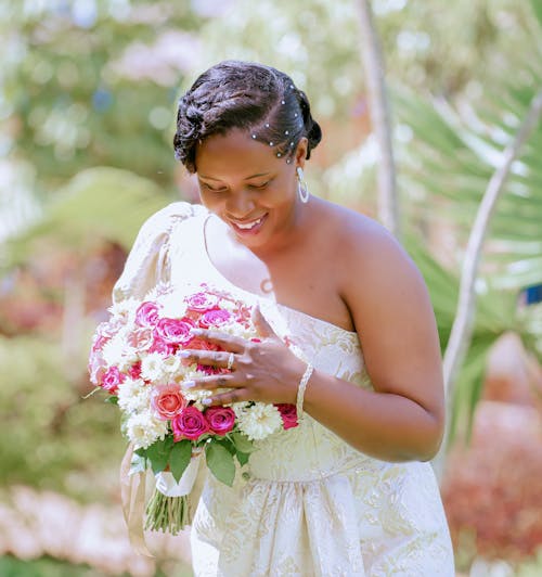 Smiling Bride with a Bouquet of Flowers