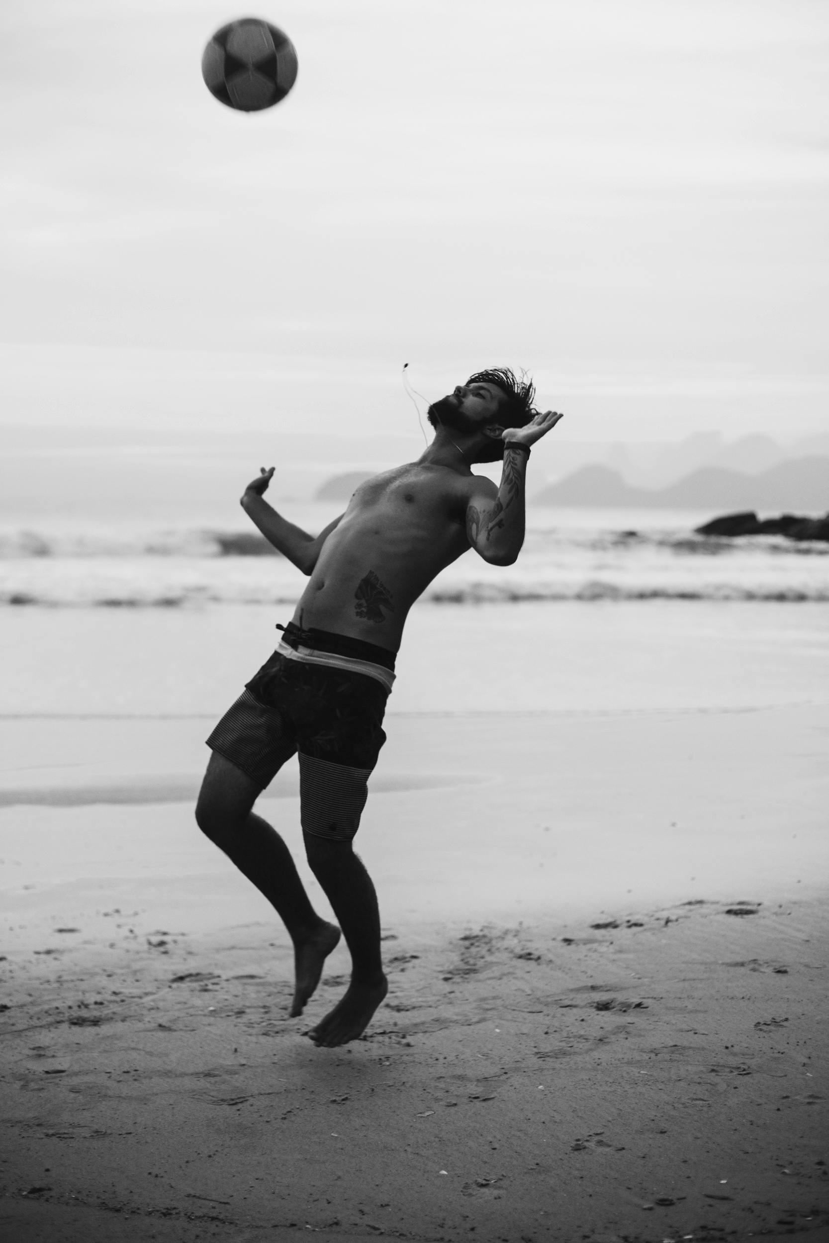 grayscale photography of man playing ball