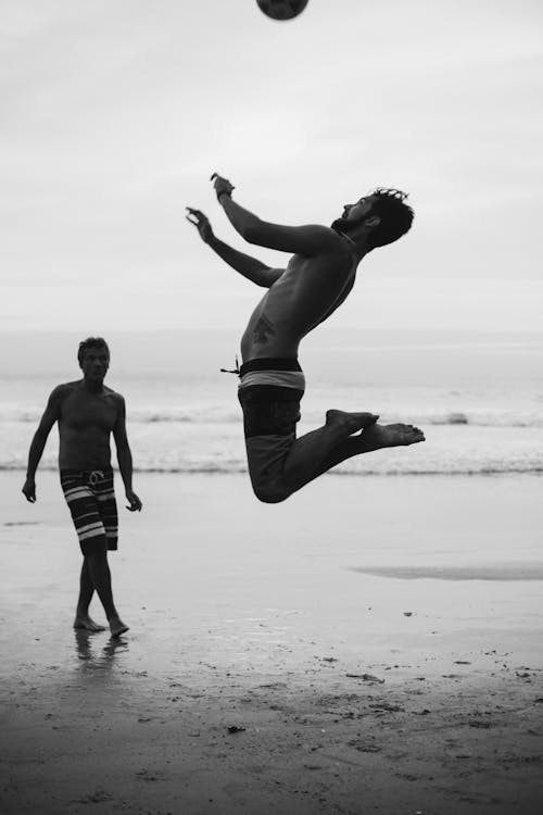 Two Men Playing Beach Volleyball