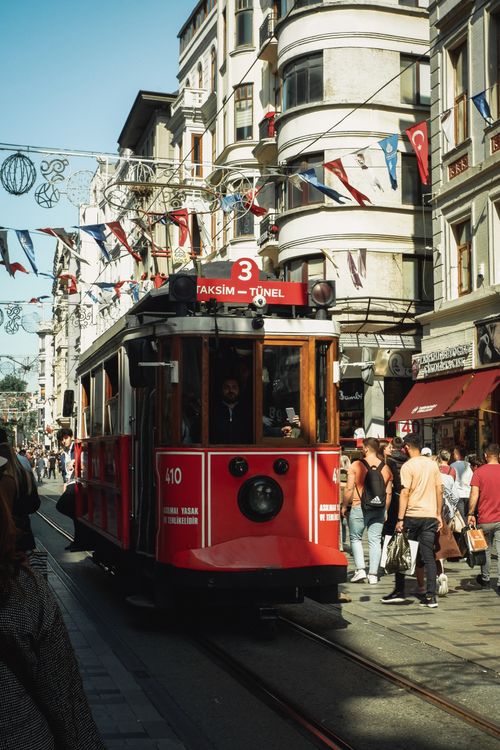 Free Vibrant scene of the iconic red tram on Istiklal Avenue, a bustling street in Istanbul. Stock Photo