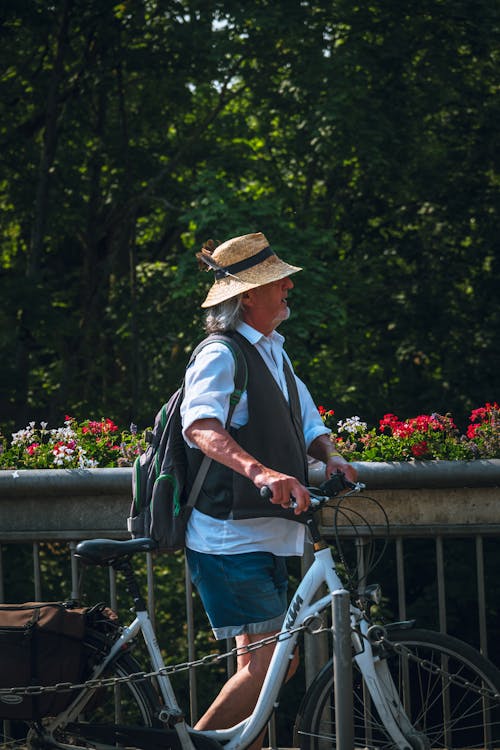 Elderly Man Walking with Bicycle