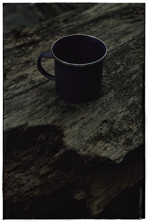 A Mug Standing on a Rough Wooden Surface 