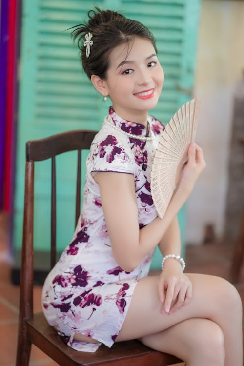 Smiling Young Woman with a Fan