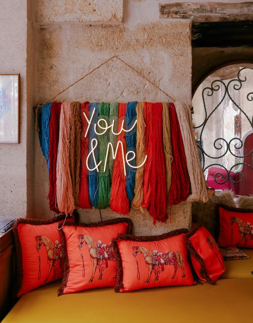 Free Charming colorful yarn decor with 'You & Me' above cozy pillows. Stock Photo