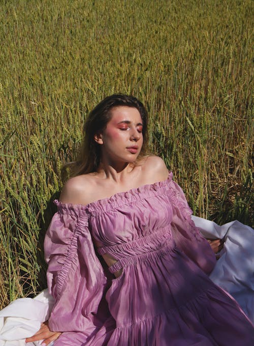 Brunette Woman Wearing Pink Dress in a Park