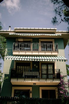 Three-story city house with balconies in Istanbul, showcasing urban residential architecture.