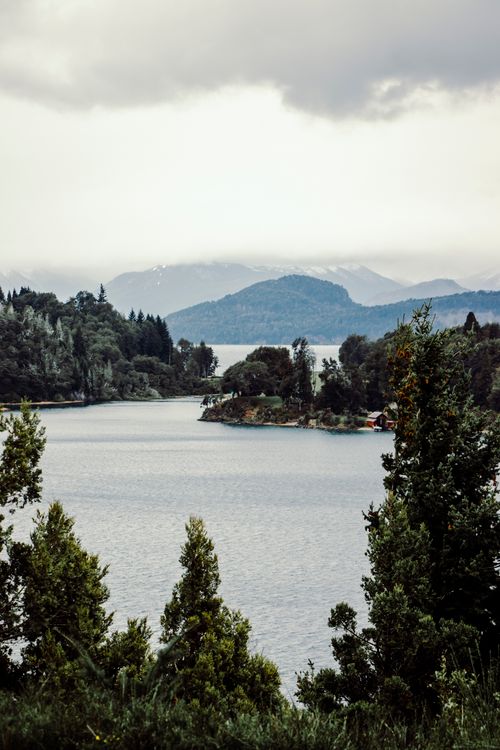 Free Stunning aerial view of a tranquil lake surrounded by lush forest in San Carlos de Bariloche, Argentina. Stock Photo