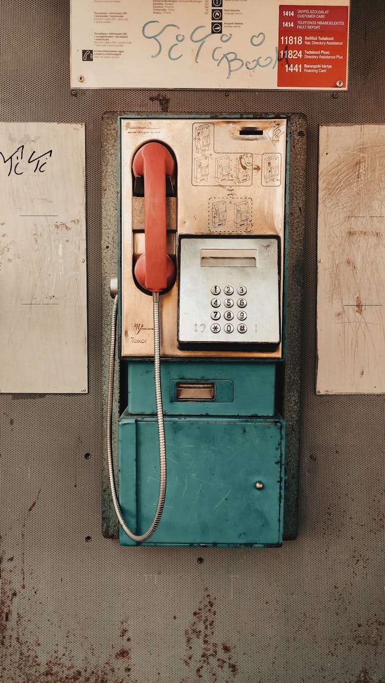 Old Pay Phone On A Gray Wall