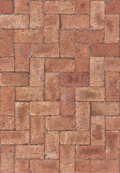 Close-up of red bricks laid in a classic herringbone pattern. Ideal for design projects.