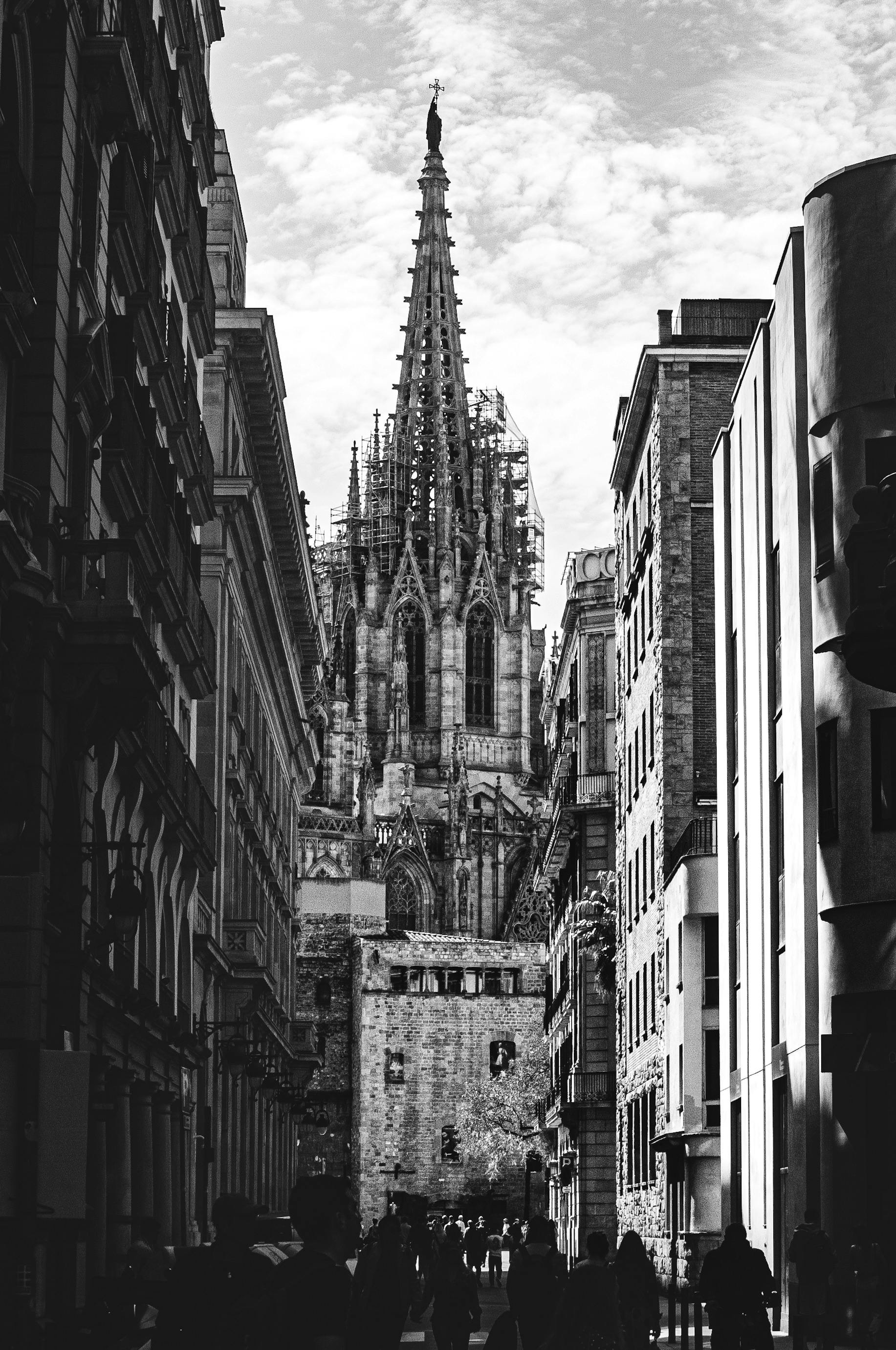 sagrada familia church in barcelona seen from the street between buildings