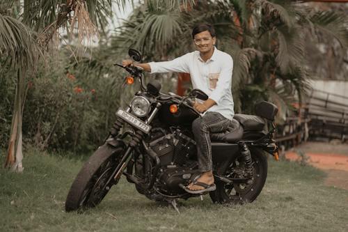 Man on a Motorbike Among Palms