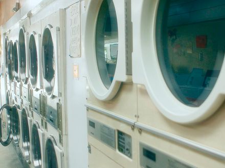 Dryer vent ducting being rerouted behind a laundry appliance