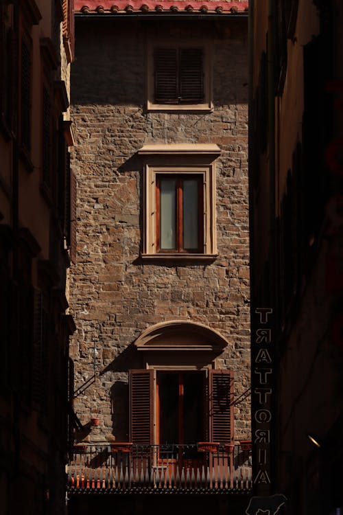 Sunlit Wall of Vintage Building in Town in Italy
