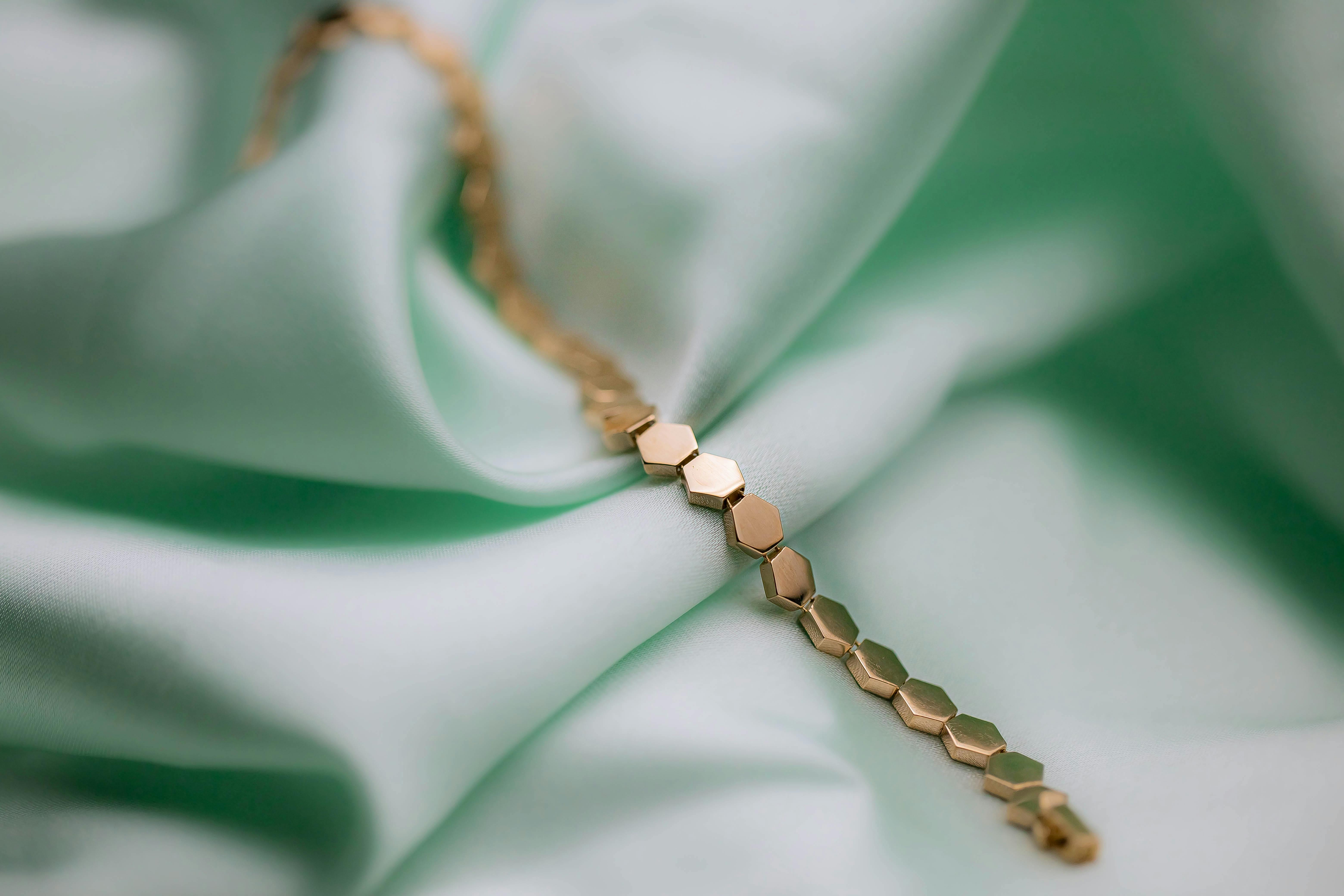 golden bracelet on green background