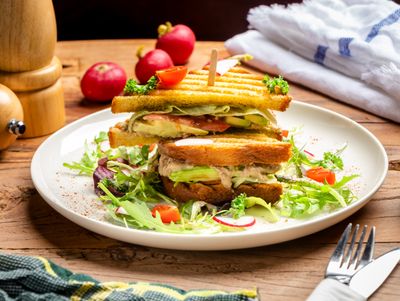 Toasted tuna club sandwich on a white plate — photo by Mitchel Guanzon on Pexels