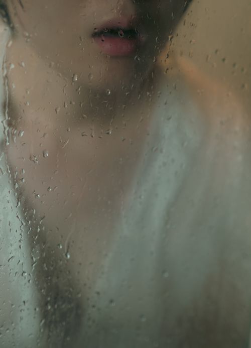 Free Close-up view of a woman behind a steamed glass pane, depicting emotions of confusion and distress. Stock Photo